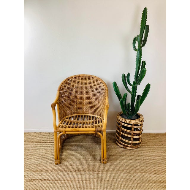 Vintage 1960s Rattan Chair made of rattan natural color woven detail at back measures appx - 22.5"W - 33"T - 25"D great...