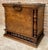 Antique solid wood chest featuring a strong architectural presence, with turned side columns, a paneled front, and an...