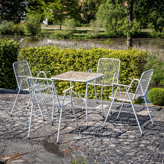 Elegant seating set made of white-painted metal, likely crafted in Italy around the mid-20th century. Comprising four...