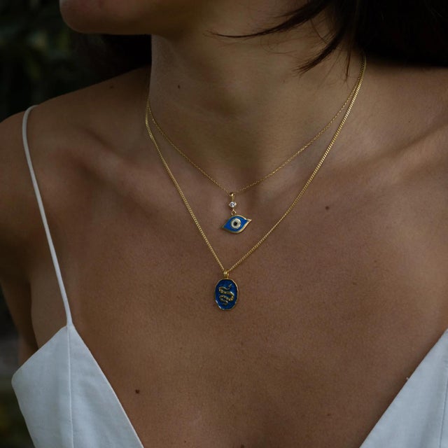Bring spiritual elegance to your style with the Celestial Protection Deep Blue Evil Eye Necklace. Designed in sterling...