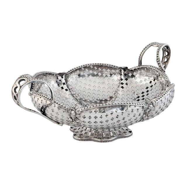 A beautiful English centerpiece or fruit and bread basket of fine plate silver from the Edwardian era, featuring a...