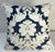A stylized embroidered damask in an ivory viscose velvet applied to a navy linen base to form a 20” X 20” sofa pillow....