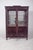 Dutch-style china cabinet with brass fittings. In dark wood with rich and striking decoration, of obvious Dutch...