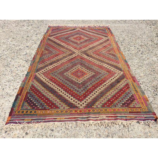 A beautiful vintage handwoven kilim. The kilim approximately 70 years old. It is handmade, of very fine quality in all...