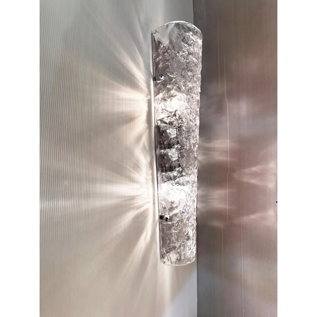 Contemporary luxury modern wall sconces made in transparent hammered Murano glass. Set of two impressive pieces in chromed...