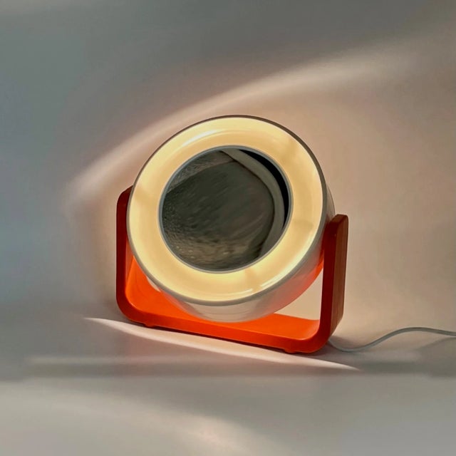 This illuminated mirror by Allibert is a quintessential example of 1960s Space Age design. Featuring its original bold...