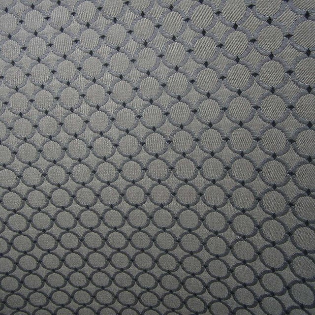 One bucket chair by Nicos Zographos. These chairs have a five star steel base on coasters and the upholstery is a gray...