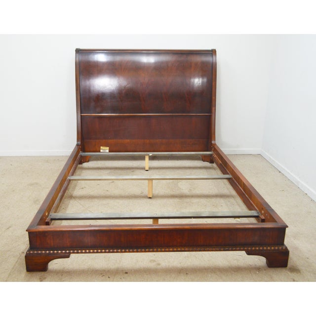 Queen Bed by Henredon. Store item #572. It features sleigh design, carved details and rich mahogany wood.