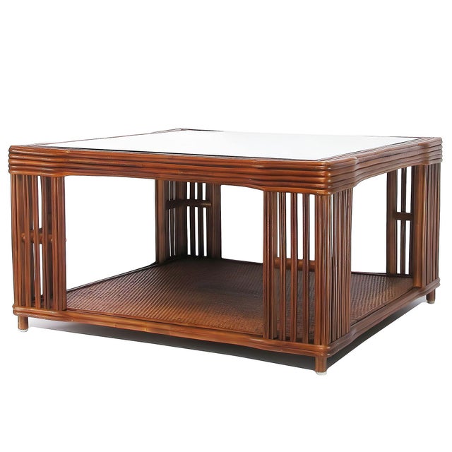 This beautifully stick rattan “Nantucket” coffee table features classic walnut finished stick rattan framing with tightly...