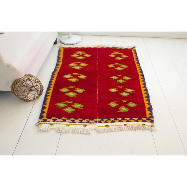This is a vintage Turkish Oushak rug from the Mid 20th Century. The piece was hand-knotted.