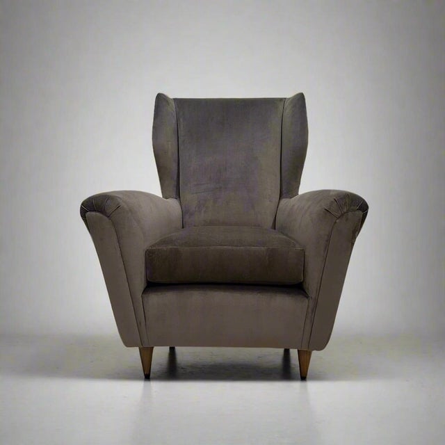 Beautiful single Italian Modernist wing chair in the style of Gio Ponti. Newly, newly reupholstered with grey velvet with...
