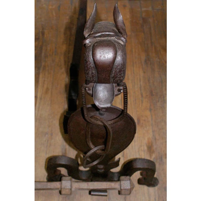 Late 19th, early 20th century folk art wrought iron andirons. These are in the form of chain mouthed griffins having cross...