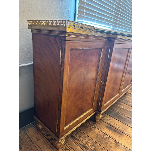 Impressive classic French Neoclassical style flame mahogany sideboard having distinctive burled wood panels, elegant gilt...
