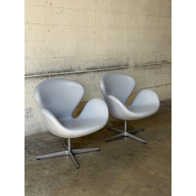 These iconic lounge chairs feature a continuous organic silhouette with curved integrated armrests. The elegant profile...