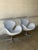 These iconic lounge chairs feature a continuous organic silhouette with curved integrated armrests. The elegant profile...