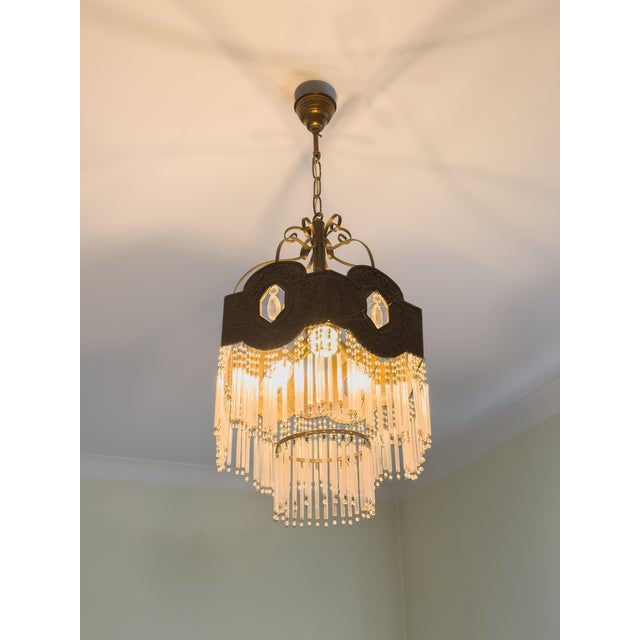 This Vintage Metal And Glass Ceiling Lamp is an example of mid-century decorative lighting. The structure is crafted in...