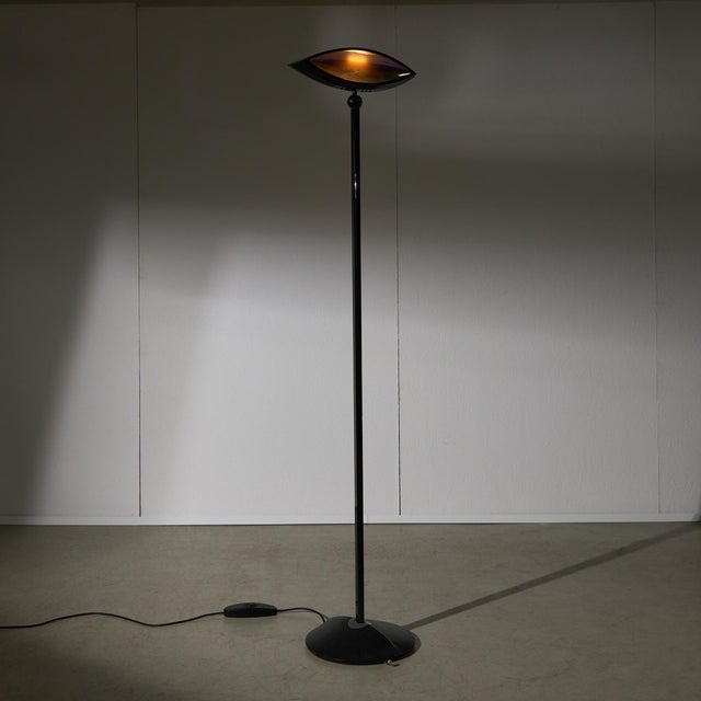 Fabio Lombardo designed the Aeto floor lamp for Flos in the 1980s, featuring a black, eye-shaped design from Italy. This...