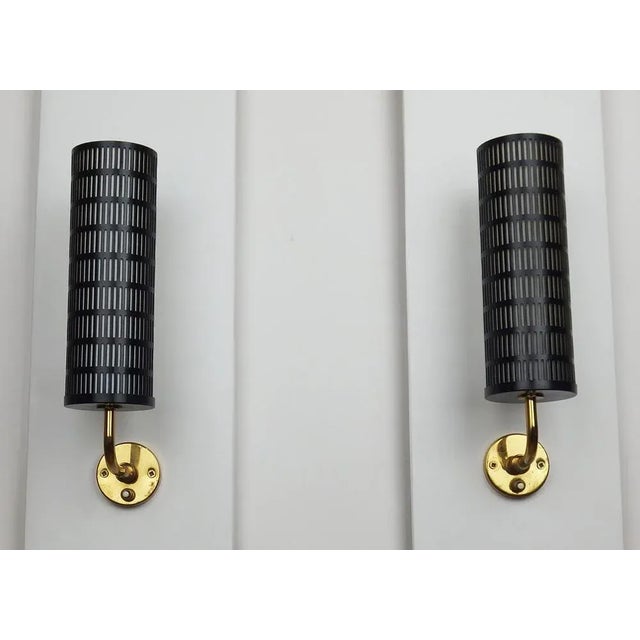 Pair of wall lights consisting of a brass fixing base equipped with a switch, an adjustable arm mounted on a ball joint, a...