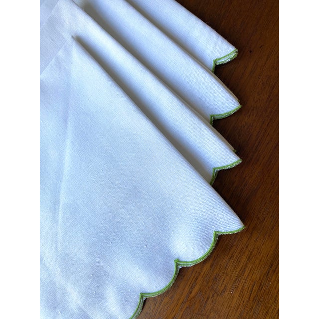 Set of four, very white, very crisp linen dinner napkins with a dramatic, green scalloped edge. A generous 17" x 17" when...