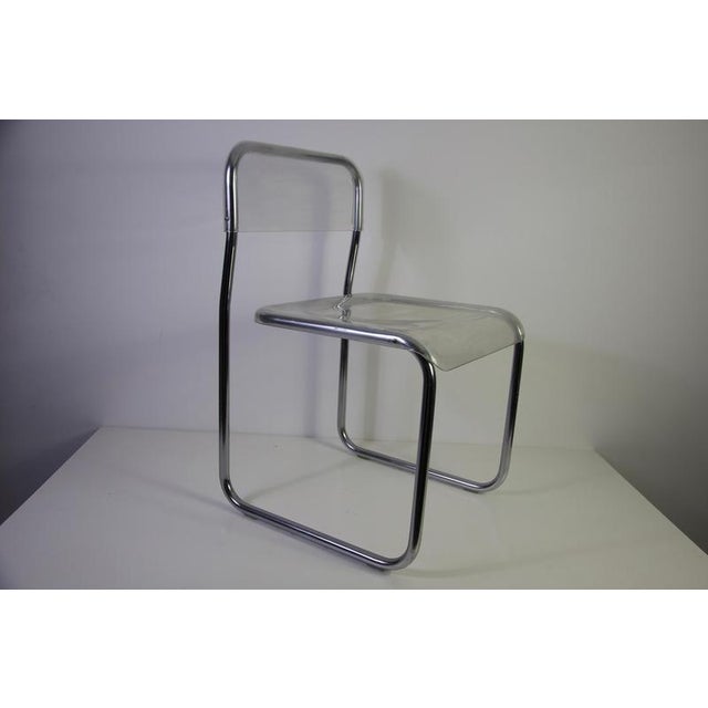 Acrylic glass and chrome chair, Germany, 1970s. This distinctive vintage chair features a sleek tubular chrome frame...