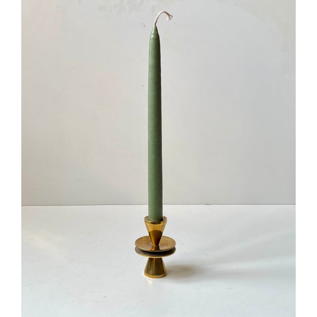 A small candlestick holder in patinated bronze. One side for a regular sized candle and the other for a taper candle. It...