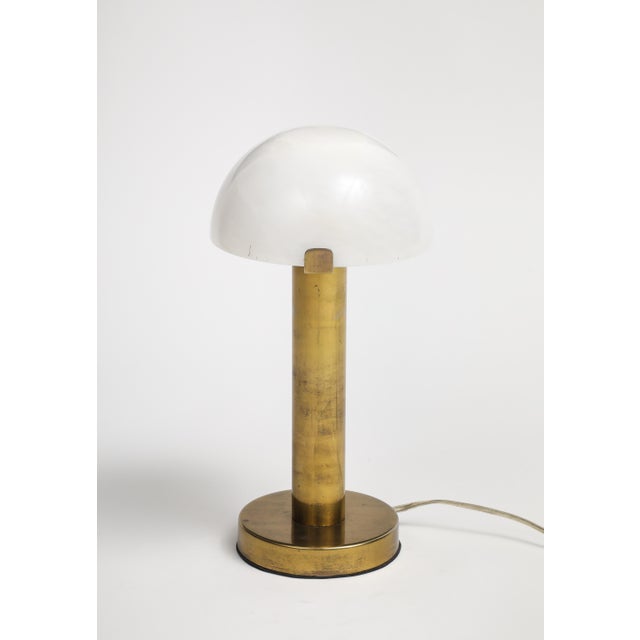 Contemporary brass table lamp with frosted glass dome shade. Base is 6" diameter, shade is 8" diameter. 16" H.