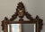 Tall gilt wall mirror in the Baroque / Rococo revival style, with a carved urn-and-floral crest, scrolled side ears,...