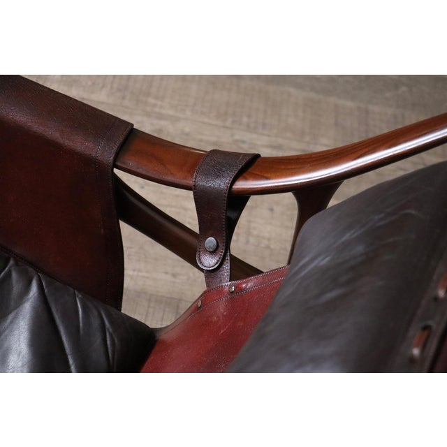 A refined Brazilian modern rocking chair, produced in the 1960s by Liceu de Artes e Ofícios. The design reflects a clear...