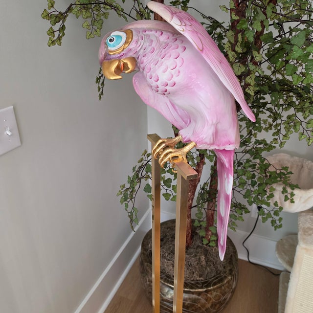 A breathtaking statement piece for the discerning collector: a monumental 57-inch floor sculpture of a tropical parrot,...