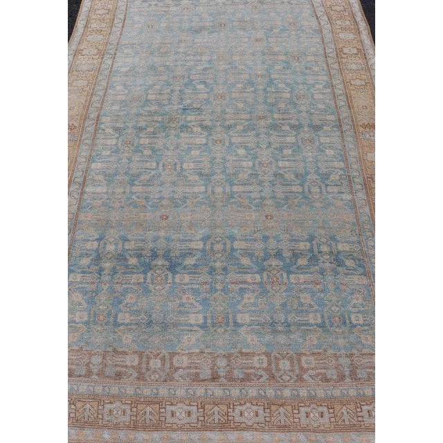 Antique Persian rug in light blue, cream, orange, brown and neutral tones with geometric motifs, Keivan Woven Arts / rug...