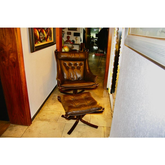 Rare lounge chair and ottoman with armrests, upholstered in leather, canvas, and bent beechwood, in very good original...