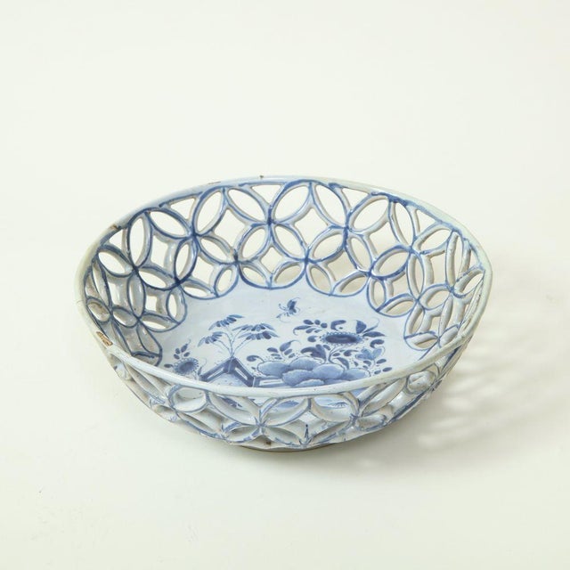 With pierced latticework sides; the interior well painted with floral blossoms and a butterfly in a garden setting.