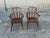 Pair Of 19th Century Low Back Solid Wood Windsor Armchairs Featuring Three Pierced And Shaped Splats With Central Set...