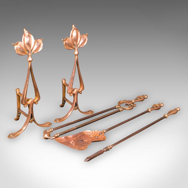 This is a superb antique fireside companion set, comprising a pair of French bronze andirons and a trio of fire tools in...