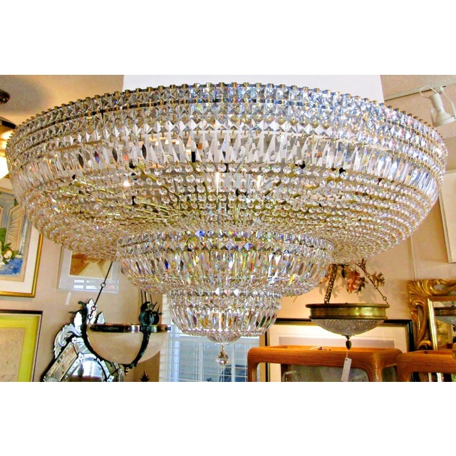 The Grand Schonbek Model Number 4897 is a 48" Diameter Petit Crystal Three Tier Flush Mount Chandelier is a luxurious and...