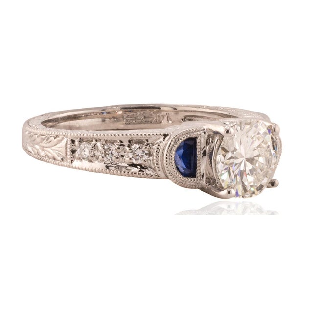 14k White gold engraved ring set with one GIA ceritfied 0.91 carat J color VVS2 clarity round brilliant and 2 half moon...