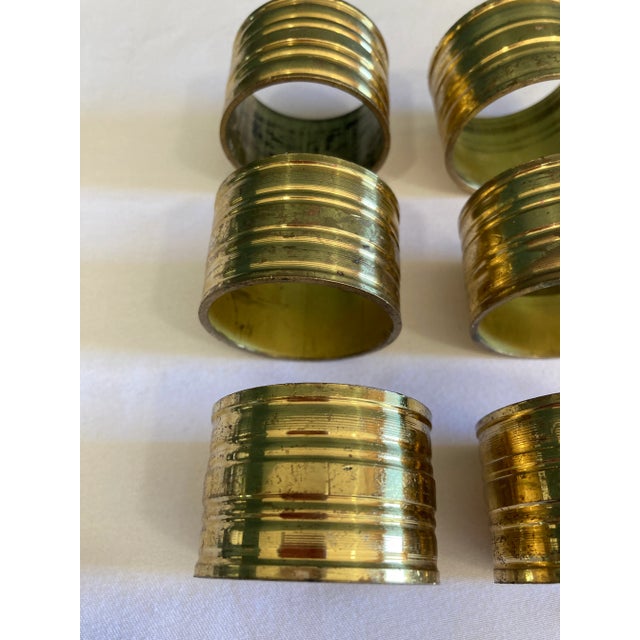 Add timeless elegance to your dining presentation with this set of six vintage ribbed brass napkin rings. The grooved...