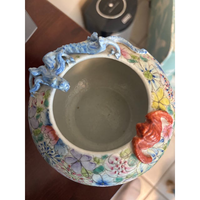 A vibrant vintage Chinese porcelain bowl or small jardinière, richly decorated in a dense all-over floral pattern in the...