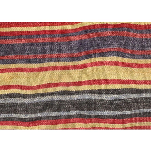 Bring a unique and traditional style to your home with this handcrafted Vintage Turkish Kilim. Boasting a classic wool-on-...