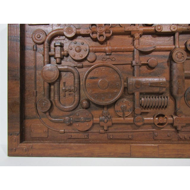 A solid wood relief that feels like a vintage control room schematic—pipes, valves, gauges, springs, and gears all carved...
