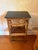 Chinese export bamboo étagère side table in burnt tortoiseshell bamboo with a black lacquered top. An open Chinese...
