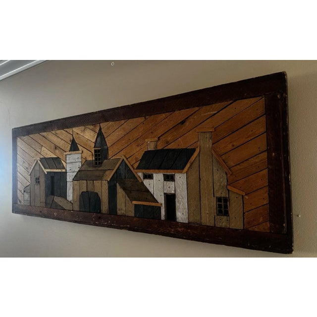 This lathe-art panel med wood panel construction in herringbone-pattern background with applied low-relief architectural...