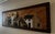 This lathe-art panel med wood panel construction in herringbone-pattern background with applied low-relief architectural...