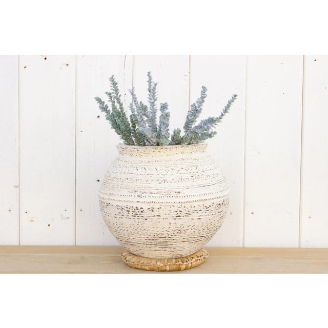 An original Nupe clay pot from Nigeria. This beautiful tribal African Terracotta pot of spherical shape has a custom...