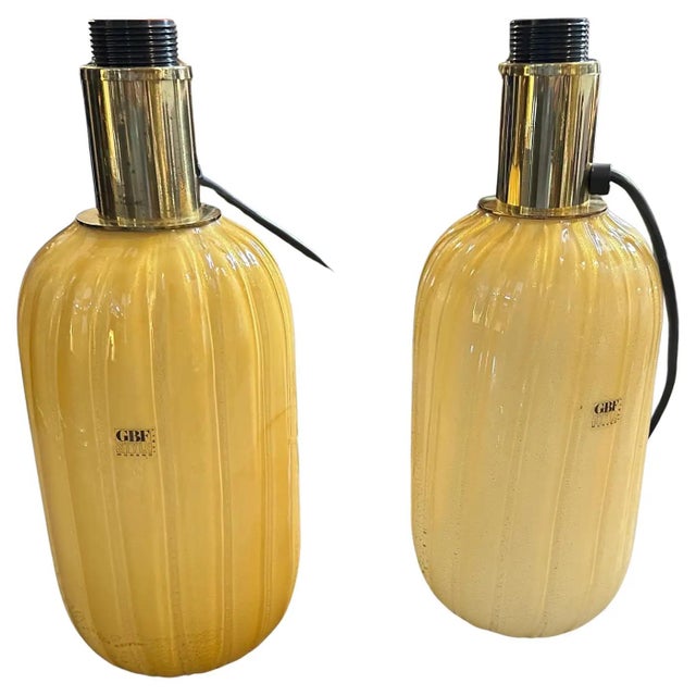 This pair of vintage table lamps from the 1980s showcases the exquisite artistry of Murano, Italy. Each lamp features a...