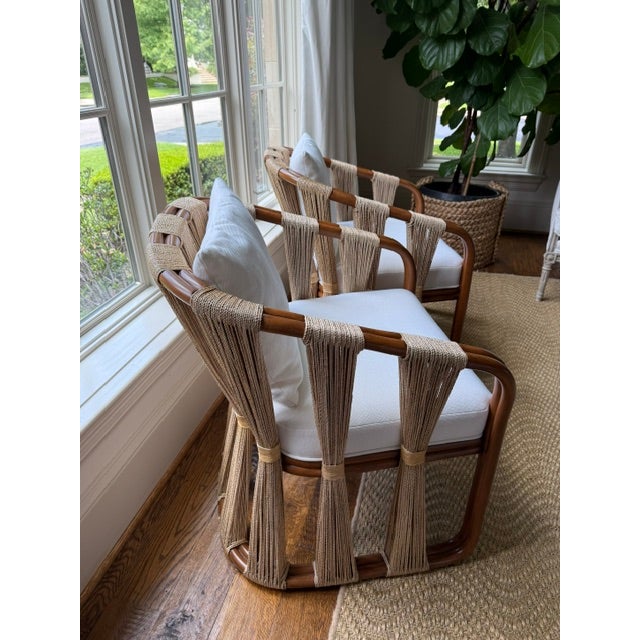 Palecek Double pole rattan frame and legs in natural finish with natural abaca rope along the sides and back. Chair comes...