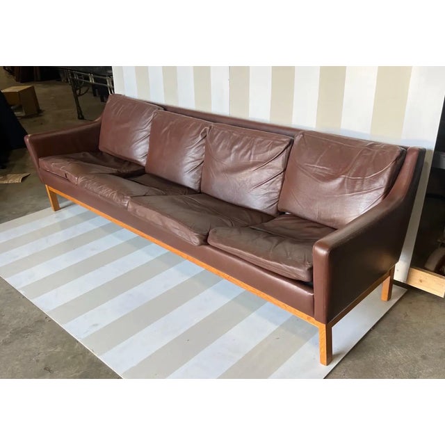 Sleek and comfortable 4 seat leather and oak Danish sofa by Erik Worts.
