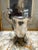Vintage silver plated brass base pitcher with fluted style legs. Marking on the bottom is hard to make out but it looks...