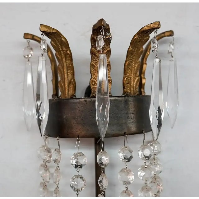 An elegant iron and crystal wall sconce or lantern by Niermann Weeks. The sconce is made of solid metal and crystals in a...