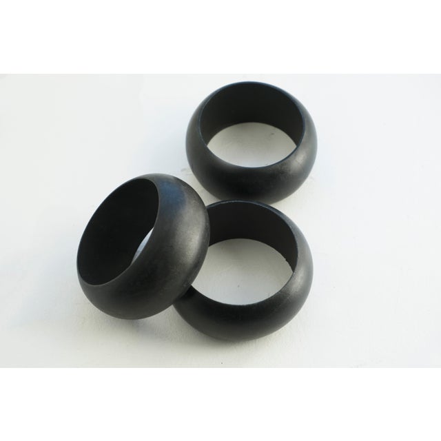 This vintage bangle bracelet is wide and chunky with a smooth matte black finish. It features a bold, domed shape that...